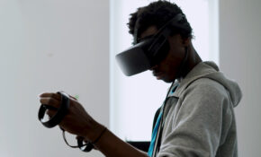 A student wears VR goggles.